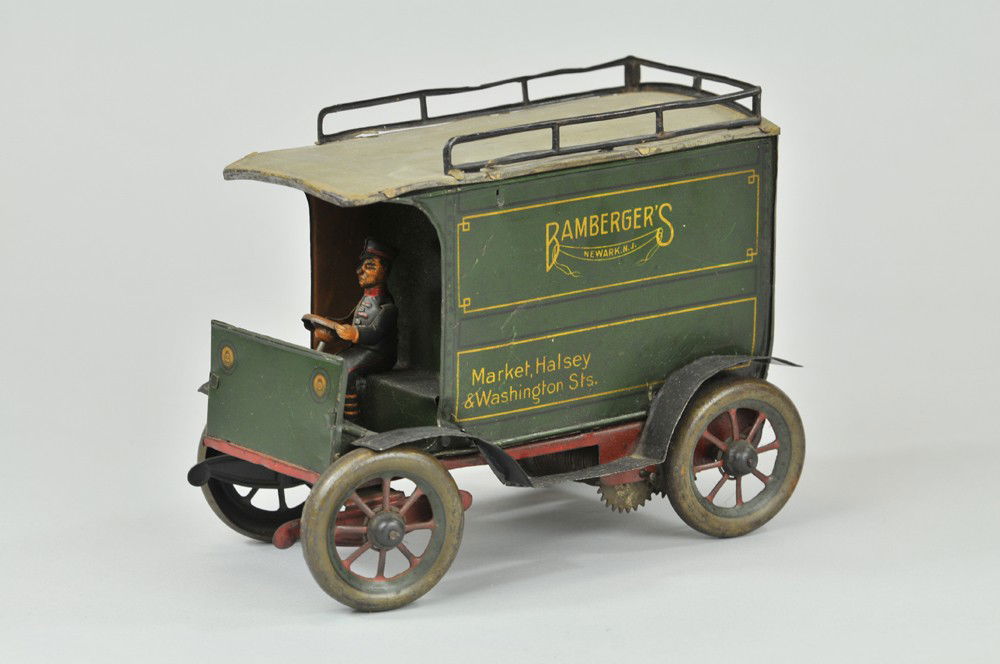 HANS EBERL "BAMBERGERS" DELIVERY VAN: Germany, c. 1930's, lithographed tin, done in green body, private label for Bamberger's of Newark, NJ, scarce example, red frame, key wind spring barrel mechanism, opening doors, seated driver. 7 1/4"
