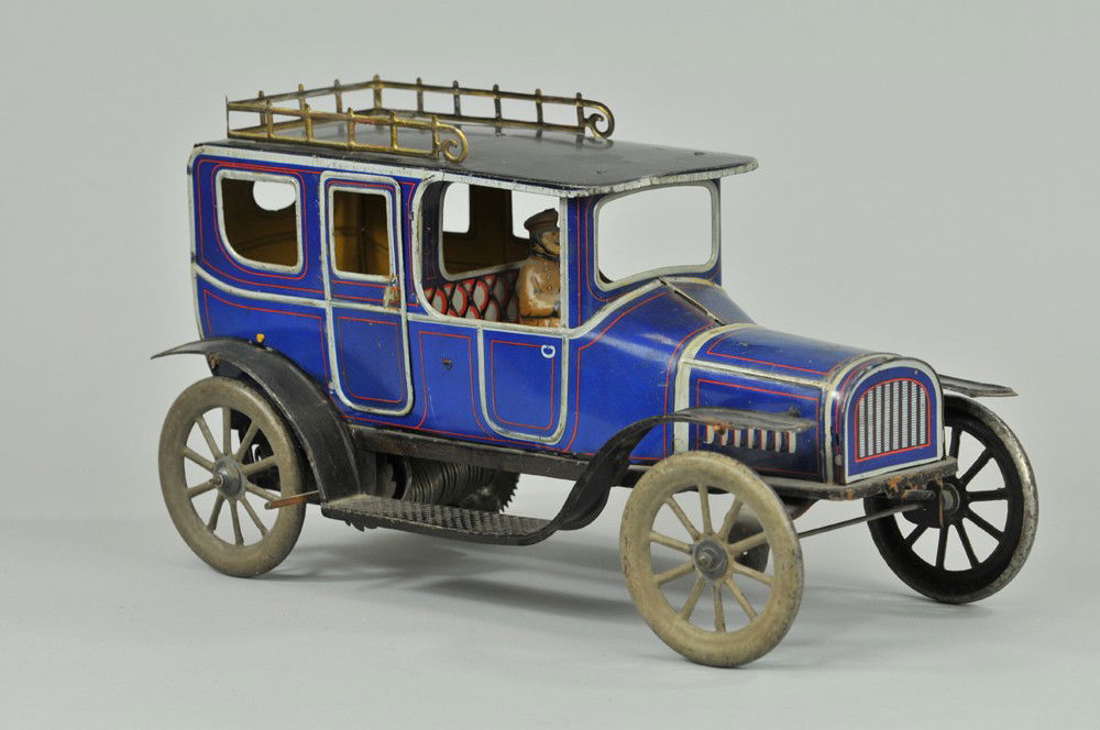 FISCHER LIMOUSINE: Germany, c. 1915, lithographed tin, done in blue body, grey striping with ornate gold finished luggage rack, black running boards, spoke wheels painted in grey, seated driver, opening doors, clockwork