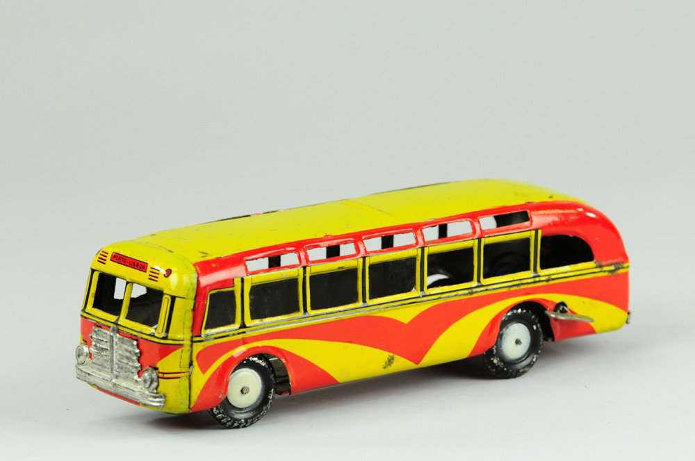 DELOUSA PORTUGESE CITY BUS: Portugal, c. 1938, Lisboa's answer to a Greyhound tour bus, done in bright red and yellow lithography, repainted roof and upper windows, features nickel grille, clockwork driven. 9 1/2" l. Factory tou