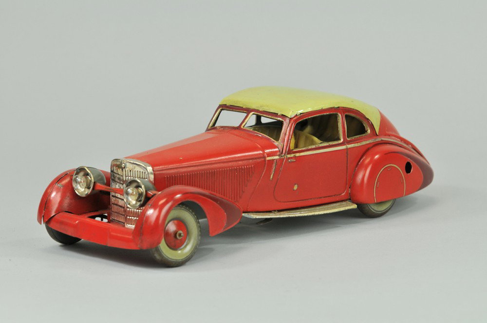 TIPPCO MERCEDES 540K AUTOBAIN: Germany, c. 1935, very sleek lines, lithographed tin, a special luxury model featuring seated driver, electric lights and clockwork mechanism, done in red body, light green roof, full covered wheel fe