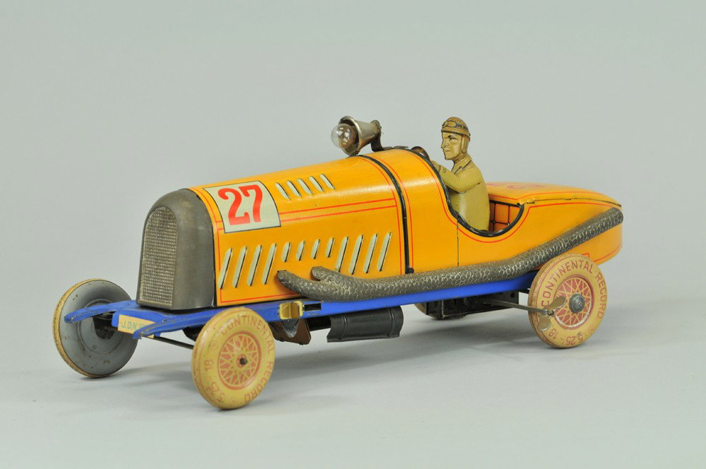 DISTLER RACE CAR: Germany, well detailed oversized tin litho racer, embossed vents along bonnet, electric spot light is hood mounted, pipes along side of body, seated tin driver, clockwork mechanism. 13" l. Fading to w