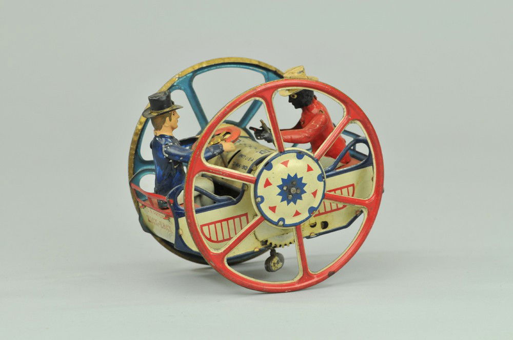 LEHMANN ZIG ZAG: Germany, hand-painted and lithographed tin, an interesting toy, large spoke wheels with two seated figures, one holds steering wheel, the other direction rod, very colorful piece. 5" x 3 1/2". (Exc. C