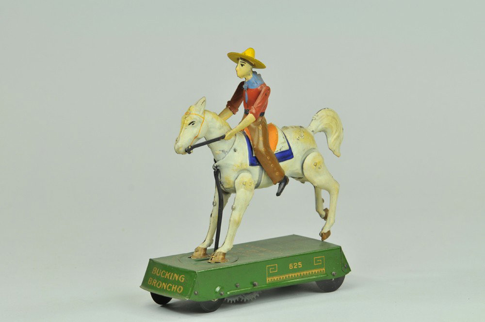 LEHMANN WILD WEST BUCKING BRONCO (WHITE HORSE): Germany, lithographed and hand-painted, curious depiction of cowboy being thrown off horse on clockwork driven base. 6" l. (Exc. Cond) 6" l.