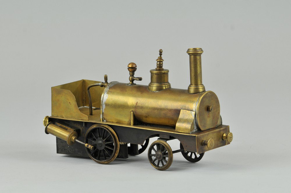SCHOENNER DRIBBLER LOCOMOTIVE: Early example, brass boiler and frame, piston rods on sides, copper engineer's open compartment, steam powered. 7" l. Minor resolder at tender compartment. (VG Cond) 7" l.