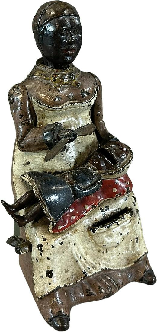 MAMMY & CHILD MECHANICAL BANK: 189. MAMMY & CHILD MECHANICAL BANK | Kyser & Rex Co. | 8" h. | Replaced trap, paint is all original in (Very Good to Excellent Condition) | $1,500 - $2,500