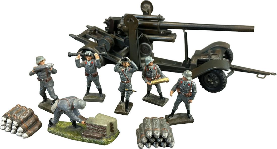 LINEOL 88MM ANTIAIRCRAFT GUN WITH FIGURES: 1011. LINEOL 88MM ANTIAIRCRAFT GUN WITH FIGURES | 88mm Flak antiaircraft gun on chassis with complete 8 pieces Luftwaffe gun crew and shells. | 13" l. | (Excellent Condition) | $400 - $800