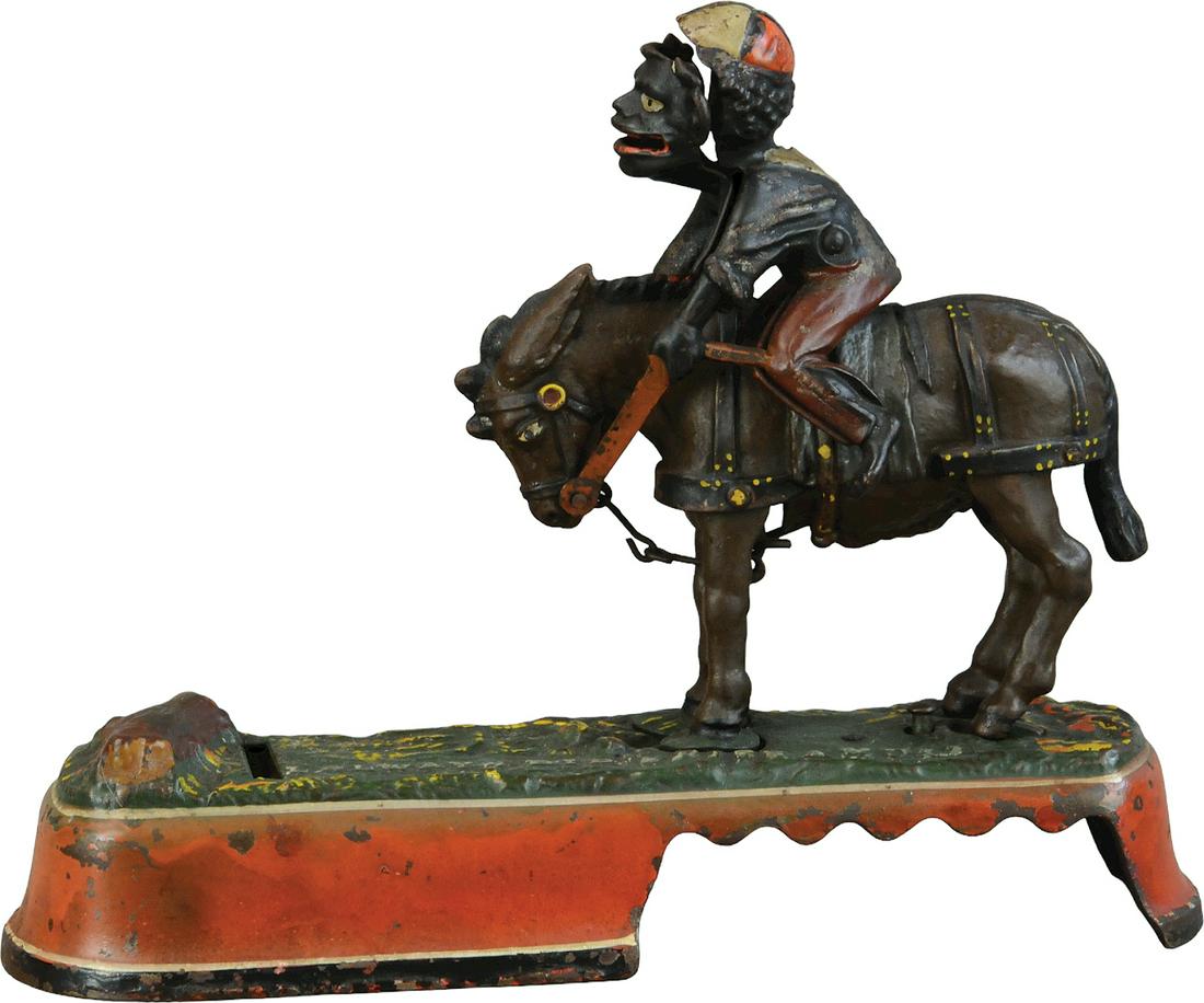 SPISE A MULE MECHANICAL BANK - JOCKEY: 1177. SPISE A MULE MECHANICAL BANK - JOCKEY | J&E Stevens Co. | 10" l. | Peen crack to one side of mans body, missing brim from his hat, paint in otherwise (Excellent Condition) | $300 - $600