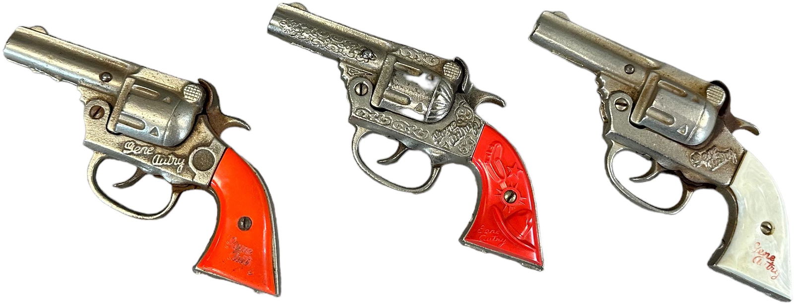 THREE GENE AUTRY CAP GUNS: 1203. THREE GENE AUTRY CAP GUNS | 7" l. | One gun is not working, (Very Good Condition) | $100 - $200