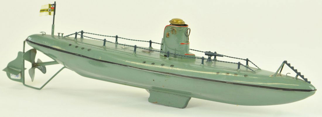 FLEISCHMANN SUBMARINE: #670/35 Germany, c.1936, painted in green overall, black striping and hand railed deck cap screw at conn, clockwork powered, flag at stern. Very rare u-boat type. 13" long.