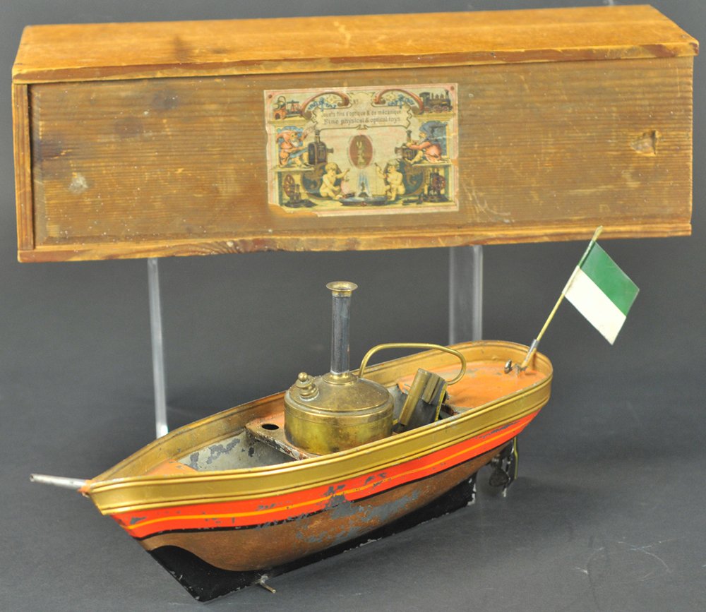 CARETTE BOXED LIVE STEAM RIVER BOAT: c.1880's, these were reportedly made for Carette by Schooner, gold painted hull, orange band, vertical boiler, hand painted deck, flag on stern, black rudder, original wooden box, internal flywheel. 1