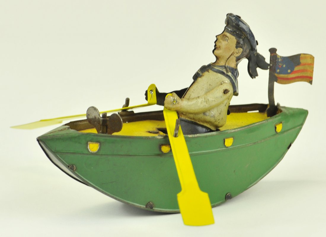 CLOCKWORK ROW BOAT: Germany, lithographed tin, unknown maker, rocking boat done in green, yellow deck, seated rower with oars in hand, flag at stern. 6" long.
