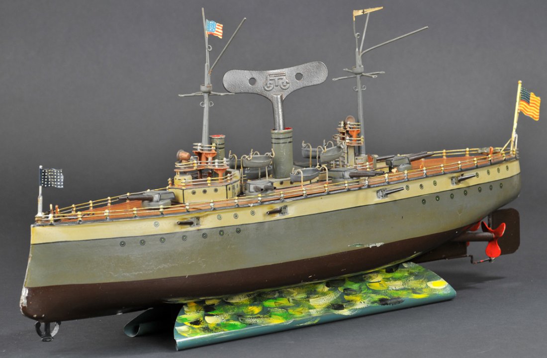 MARKLIN BATTLESHIP: #5129/52 Germany, c.1915, a very elaborately, appointed war ship, classic design, hull painted in green crème band, fully railed deck, done in a natural brown color, features guns on swivel turrets, 