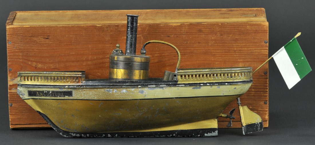 SCHOENNER RIVER BOAT WITH BOX: Germany, c.1882, live steam powered, open hull with railed bow and stern, painted in gold, label reads, "Angostura," on bow and marked J.S. original wooden box. 10" long.