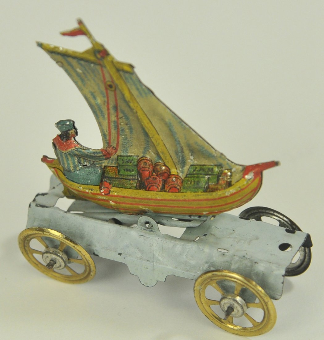 MEIER MAN IN SAILBOAT PENNY TOY: Germany, lithographed tin, nice stamping of man in sailboat loaded with goods, very colorful, attributed action. 3" long.