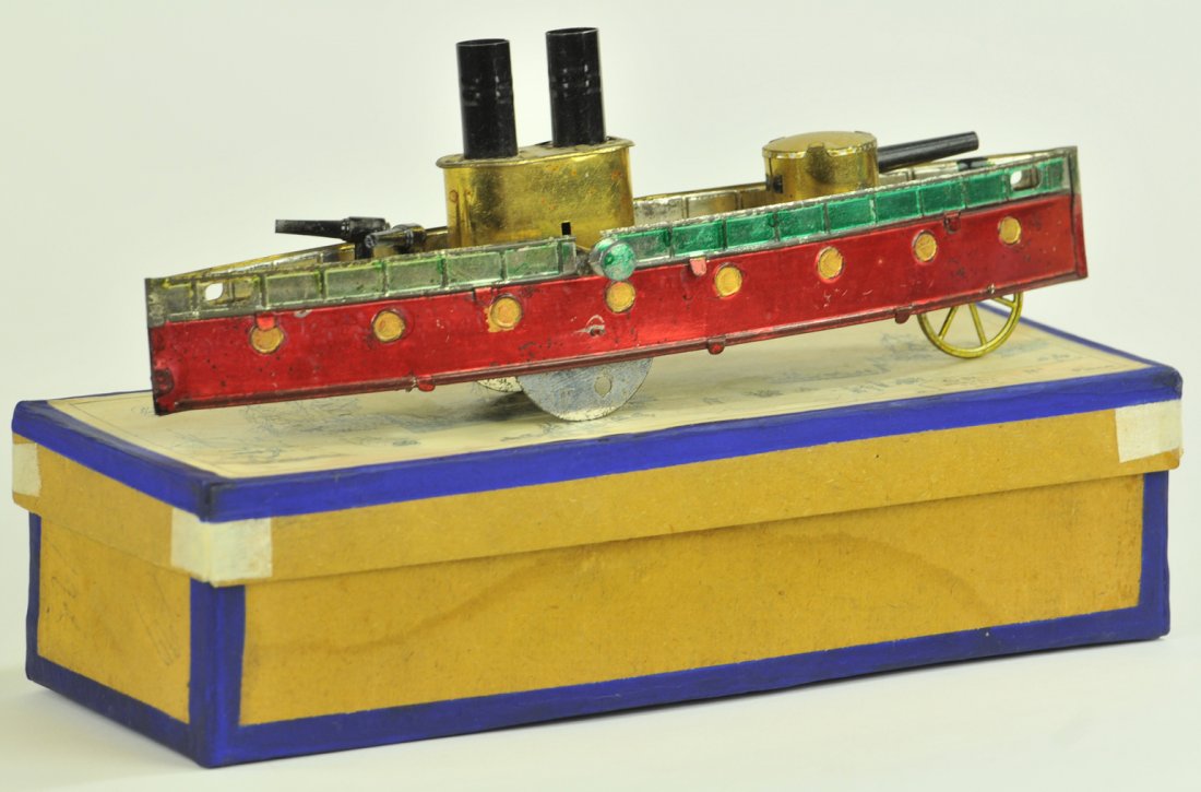CHARLES ROSSIGNOL GUN BOAT WITH ORIGINAL BOX: #107 France, early 1900's, spirit painted in red hull, gold deck and appointments, features two swivel guns at bow, gun turret at stern, two funnels. 9" long.