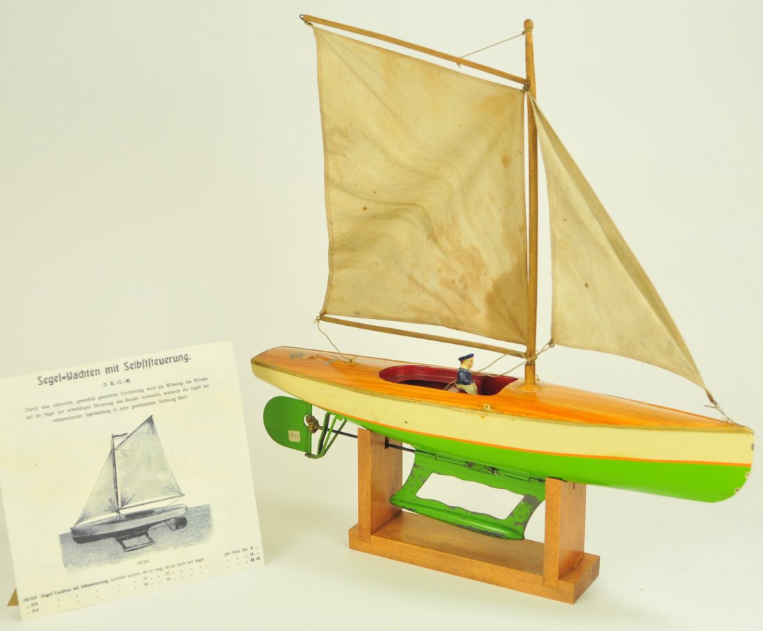 BING SAILBOAT: #155/312 Germany, c.1912, smallest of three in series, gearing at rudder controlled by wind speed, hull done in bright green and white, natural painted wood decking, cloth sails still retains Bing dec