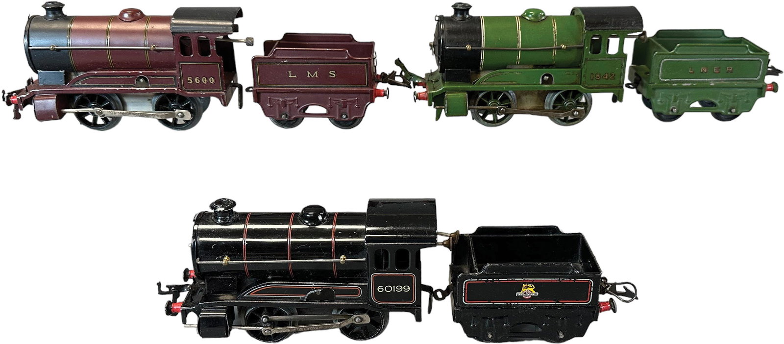 THREE WIND-UP HORNBY LOCOMOTIVES: 60. THREE WIND-UP HORNBY LOCOMOTIVES | 0 gauge, clockwork. | 6.5" l. loco | Minor touch-up to scratch on roof of LMS loco, (Excellent to Pristine Condition) | $200 - $400