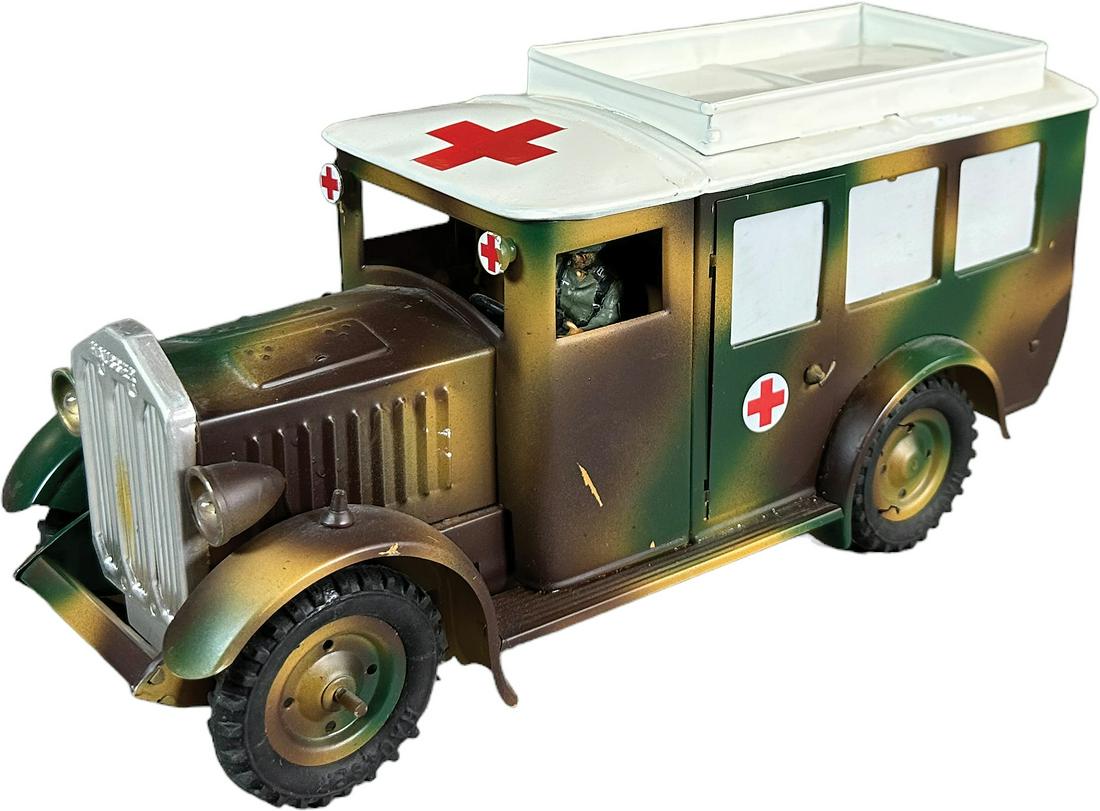 CONTEMPORARY HAUSSER AMBULANCE: 125. CONTEMPORARY HAUSSER AMBULANCE | Recent production of a Hausser large ambulance, clockwork electric lights. | 11" l. | Missing wounded on stretchers and fender pennants, otherwise (Near Mint Cond