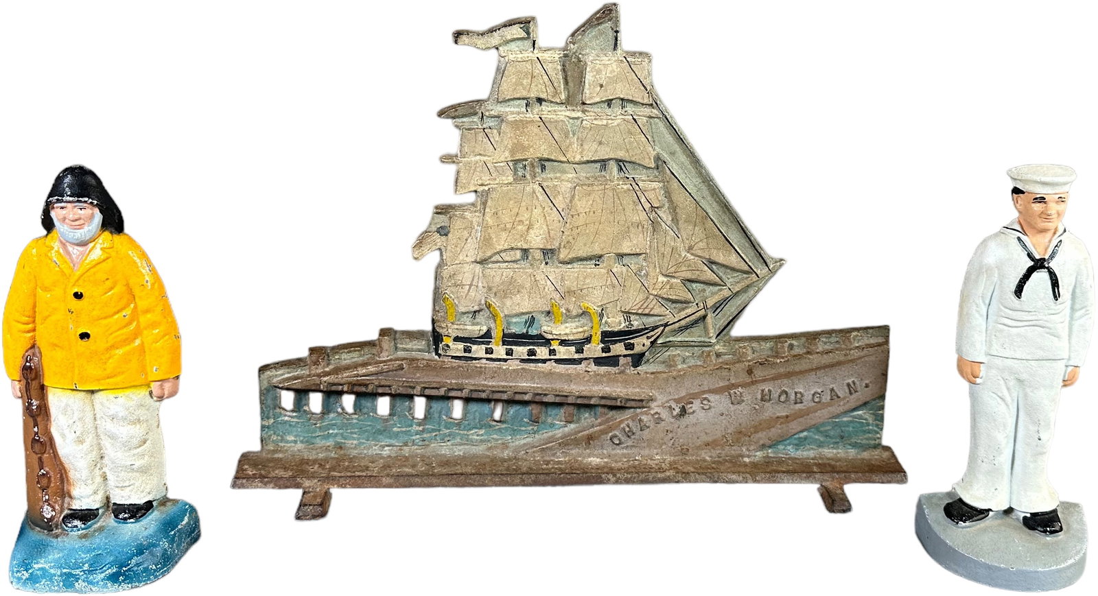 WHALING SHIP W/ A SAILOR & OLD SALT DOORSTOPS: 1324. WHALING SHIP W/ A SAILOR & OLD SALT DOORSTOPS | Charles W Morgan Whale, Ship Wedge doorstop, Sailor at attention & Old Salt holding net. Ship embossed - "P.F. Gay. No. Dartmouth, Mass. Copyright