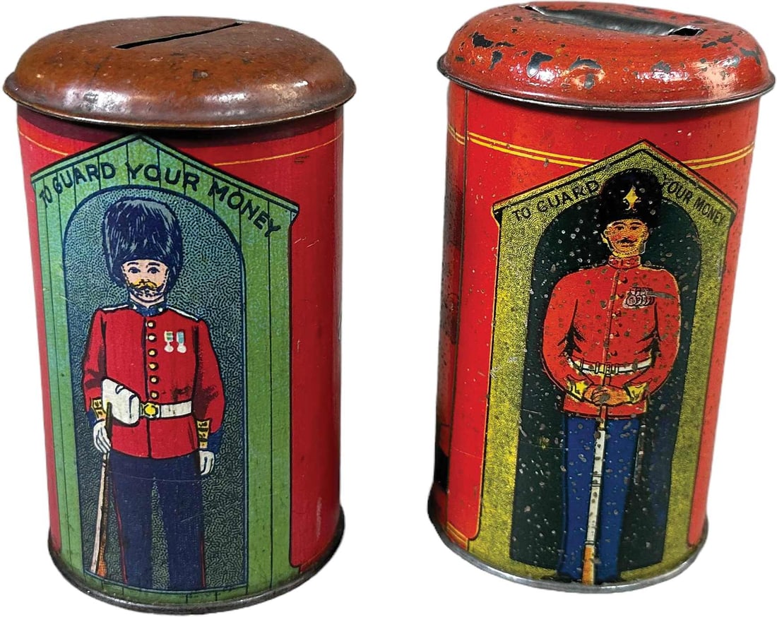 TWO ENGLISH SENTINEL GUARD TIN BANKS (1 of 4)