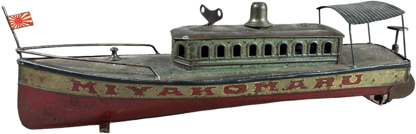 JAPANESE MIYAKOMARU WINDUP BOAT: 103. JAPANESE MIYAKOMARU WINDUP BOAT | 17" l. | Flag and rear canopy are replaced, original litho is lacquered to prevent wear, (Very Good Condition) | $500 - $1,000