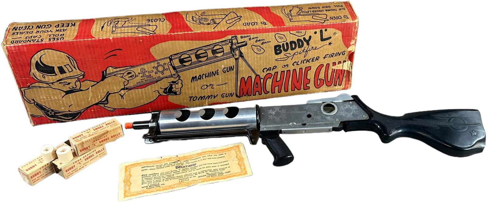 BOXED BUDDY L SPITFIRE MACHINE GUN: 341. BOXED BUDDY L SPITFIRE MACHINE GUN | 26" l. | Missing one inner flap to box, with instructions and rolls of ammunition, (Very Good to Excellent Condition) | $250 - $500