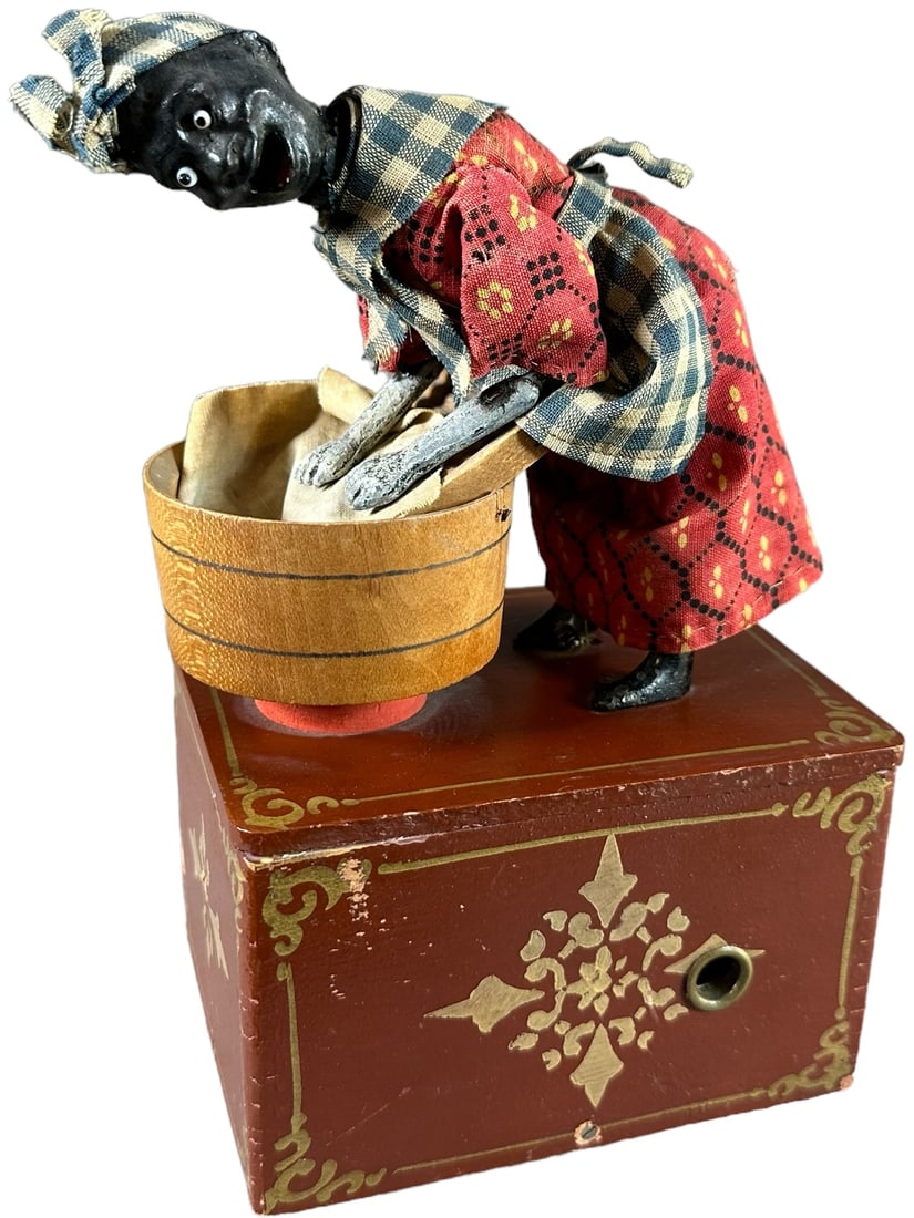 IVES OLD AUNT CHLOE WASHER WOMAN: 103. IVES OLD AUNT CHLOE WASHER WOMAN | Scarce early American clockwork toy, when wound it depicts Old Aunt Chloe rigorously washing clothes up and down in her wash bin, hand painted and stenciled woo