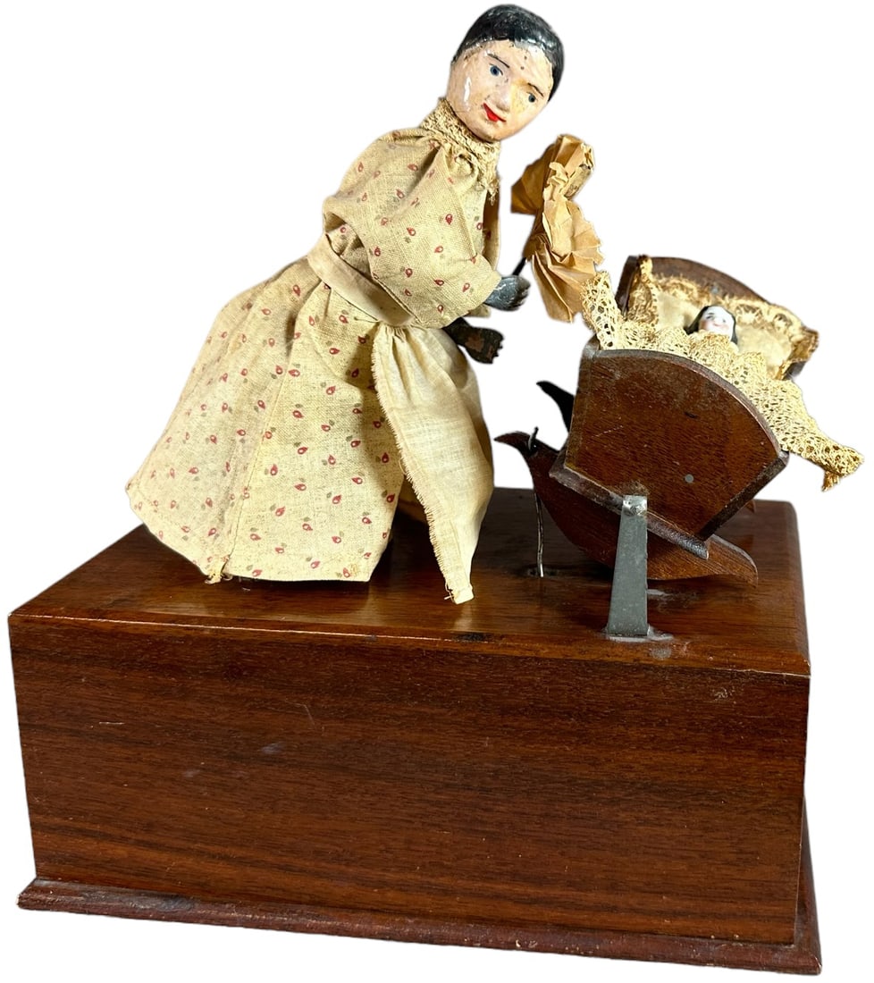 AUTOMATIC TOY WORKS GRANDMA ROCKING CRADLE: 161. AUTOMATIC TOY WORKS GRANDMA ROCKING CRADLE | Extremely rare piece, early American clockwork toy action involves Grandmother's head moving up and down as one of her hands fans the baby, while the