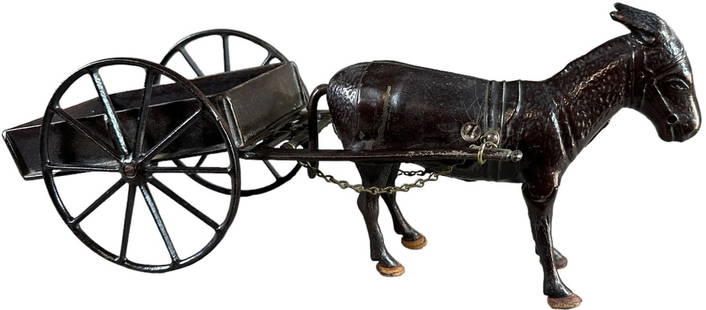 IVES CART WITH WALKING MULE: 190. IVES CART WITH WALKING MULE | Classic cast iron toy with a japanned finish, circa late 1890s, features open bed hay cart, drawn by donkey with articulated legs which still retains the original le