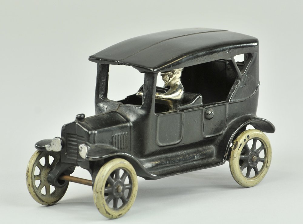 ARCADE MODEL "T" TOURING CAR: Arcade, cast iron, painted in black overall, simulated soft top model, spoke wheels, seated driver. 6 1/2 l."