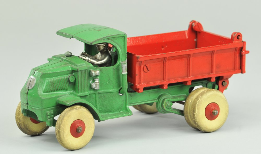 HUBLEY MACK DUMP TRUCK: Cast iron, large scale "C" Mack cab with nickel seated driver, painted in green, dump body with opening tailgate done in red, white rubber tires with dual tires on rear axle. 10 1/2" l.