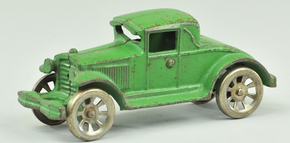 ARCADE COUPE WITH RUMBLE SEAT: c. 1930's, cast iron, scarce example, painted in green overall, tin opening rumble seat, nickel spoke wheels. 5 3/4" l.