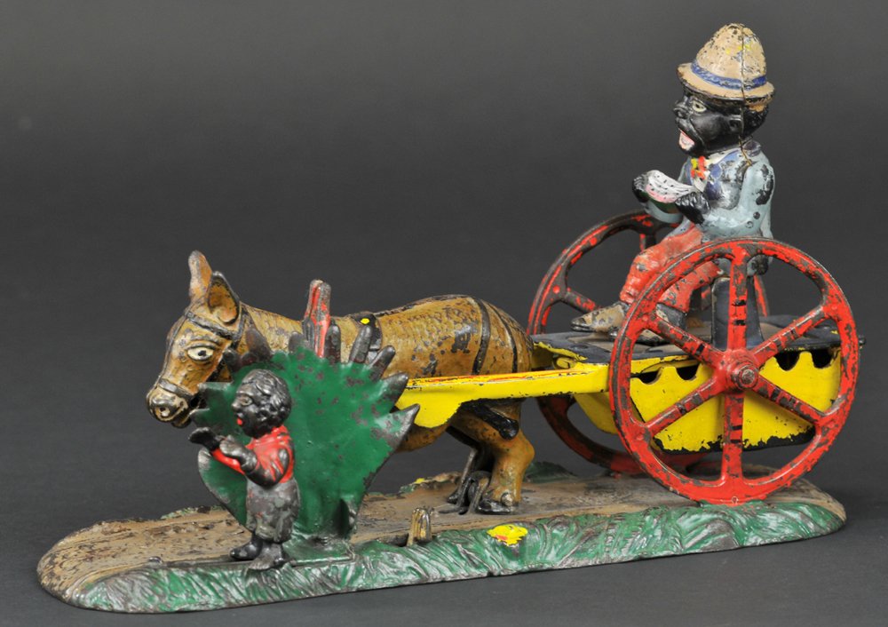 BAD ACCIDENT MECHANICAL BANK: Upside down letters, J & E Stevens Co., designed by Charles A. Bailey, circa 1890. Place a coin under the feet of the driver, and press the lever. The boy jumps into the road, frightening the donkey, 