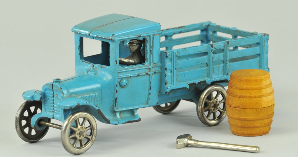 ARCADE FORD MODEL "T" STAKE TRUCK: c. late 1920's, a very scarce example done in cast iron and painted in blue overall, full stake side body, separate cast stake tailgate, nickel driver and spoke wheels. Ex. Donald Kaufman Collection 9