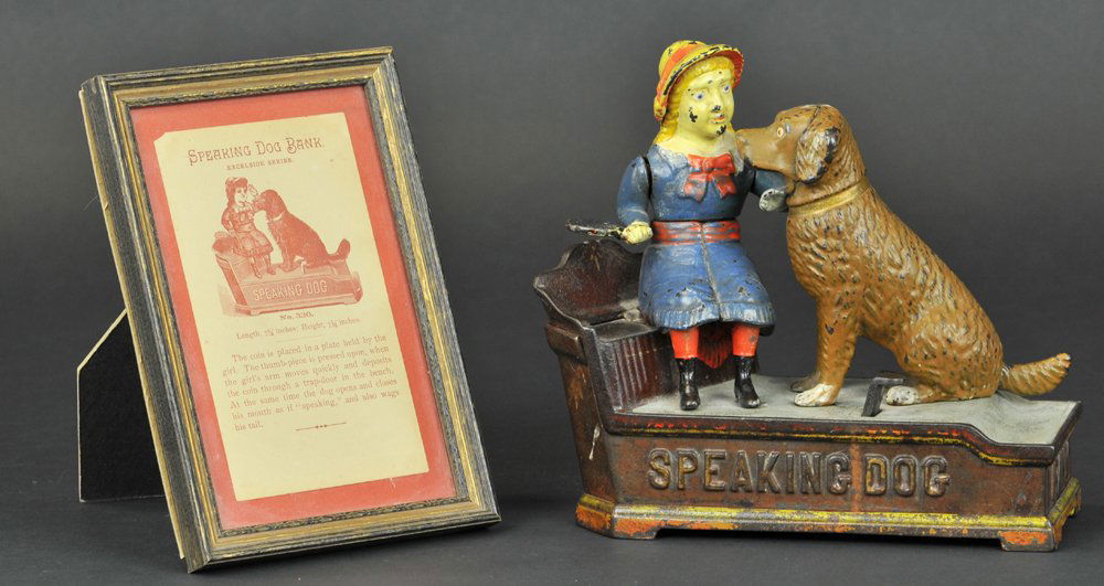 SPEAKING DOG MECHANICAL BANK: Blue dress, Shepard Hardware Co., designed by Charles Shepard & Peter Adams, patented 10/20/1885. The coin is placed in a plate held by the girl. The thumb piece is pressed upon, when the girl’s arm