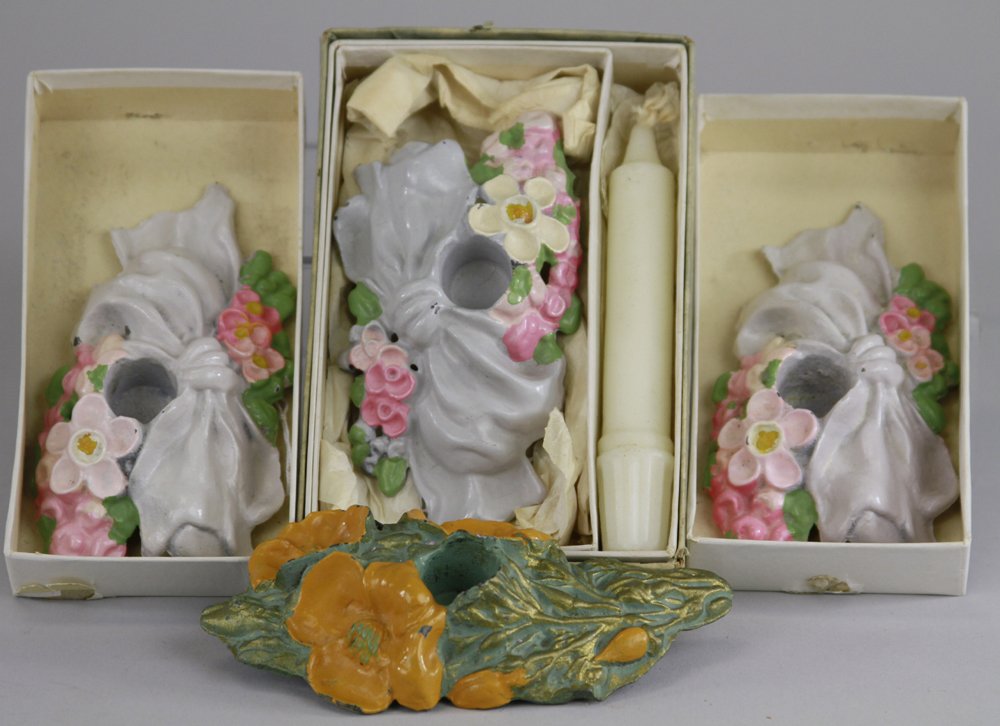 LOT OF FOUR FLOWER CANDLESTICK HOLDERS: "Candlestick Company, Minneapolis," incredible find of three cast iron, mint in the box cast iron candlestick holders; one in original packing with candle, marked "LVL Pat. 12-2-24," one set in hand p