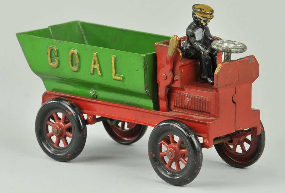 KENTON AUTO COAL WAGON: circa. 1908, cast iron, No. "844" embossed on side, done in red open cab and green dump bed, embossed "COAL" on sides, spoke wheels, seated driver, 1908 tag hangs from lever, incredible condition. Ex.