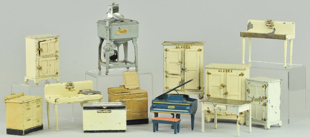 ASSORTED CAST IRON KITCHNEN APPLIANCES & FURNITURE: Arcade, includes: Alaska Ice boxes in two sizes, Maytag washer, small Frigidaire Ice chest table, Kohler and Crane sink, piano, and two Roper ranges. 2 3/4" - 8" h.