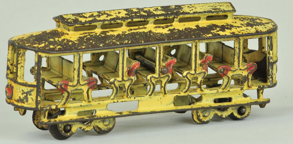 KENTON TROLLEY: Kenton, scarce example, cast iron, painted in white overall w/red trimmed sides, features open cast benches, wheels allow pulling of toy. 8" l.