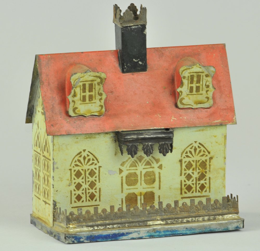 GEORGE BROWN BUILDING BANK: Hand painted and stenciled, dormers at second floor, red roof, ornate tin molding over door and front fence, coin slot appears at rear of building. 6 1/4" h.