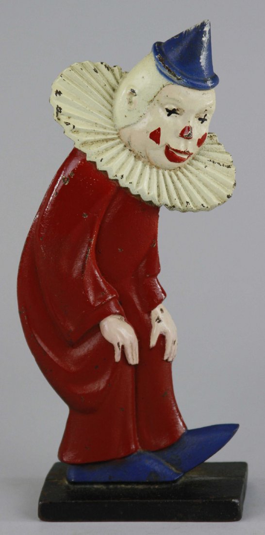 TWO-SIDED CLOWN DOORSTOP: Double sided, deeply casted w/intense details & strong colors that surround this attractive example, depicts early clown w/white face in hunched pose, wears exaggerated red suit w/collar, rare piece. 
