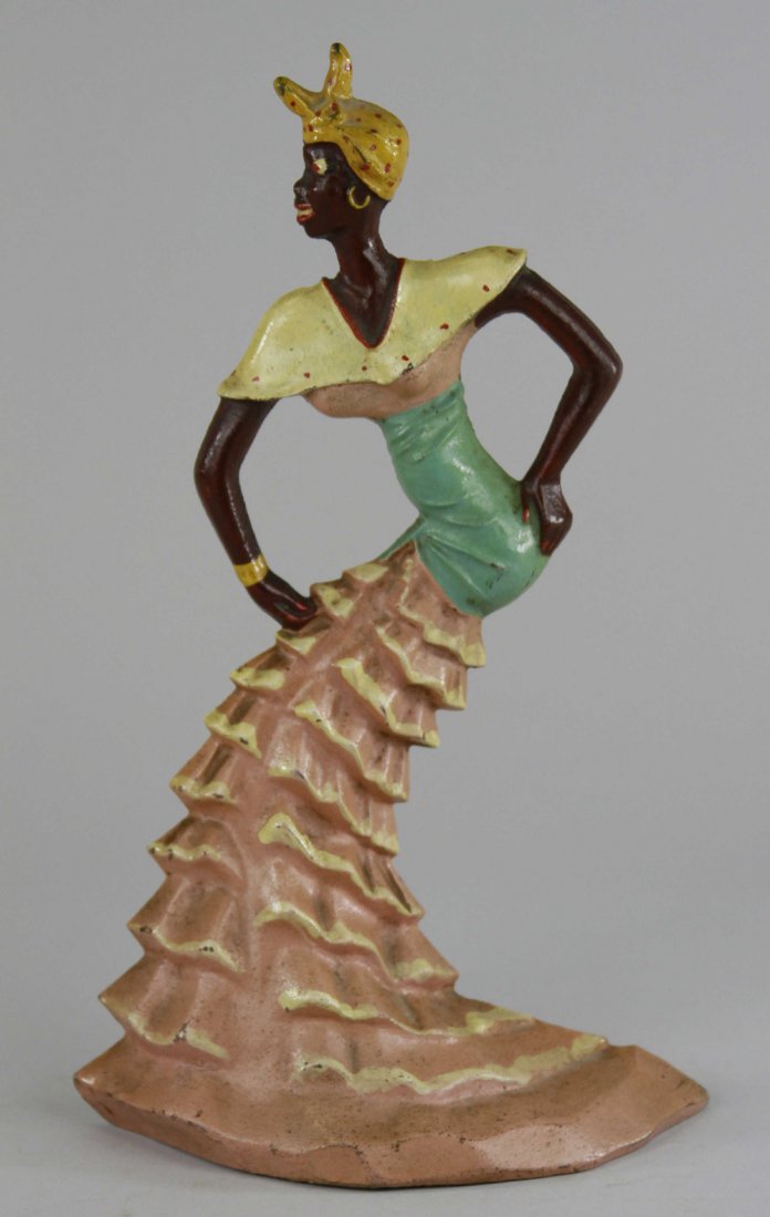 RHUMBA DANCER DOORSTOP: Cast iron, outstanding form, very desirable, features full length ruffled dress doubling as base, beautiful pastel variation w/detailed hand painting. 11 1/8" x 6 3/8".