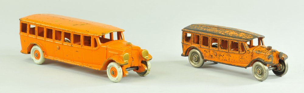 LOT OF TWO KENTON BUSES: Cast iron, each painted in orange overall, one has nickeled wheels, one has painted centers. 5 3/4" - 7 3/4".