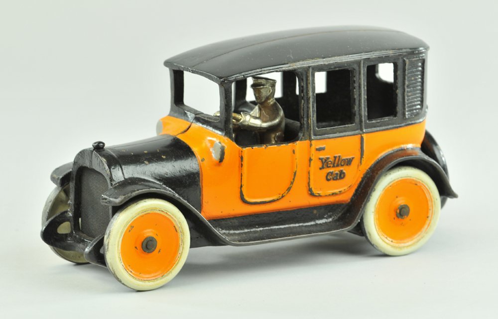 ARCADE YELLOW CAB (EMBOSSED LETTERING): Scarce example, done in orange and black, orange disc centers with white wheels, nickel driver, embossed "Yellow Cab" on doors, cast spare on trunk. Ex. Donald Kaufman Collection 9" l.