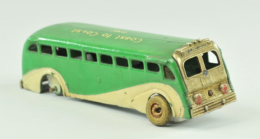 ARCADE GREYHOUND BUS: Late 1930's, cast iron, rare green and white version, "Coast to Coast" stenciled on roof, nickel plated front, rubber tires. 9" l.