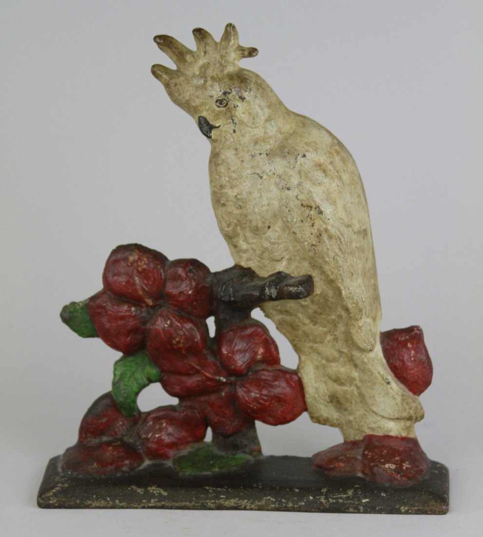 WHITE COCKATOO ON DOGWOOD BRANCH DOORSTOP: Cast iron, depicts white cockatoo perched on dogwood branch w/painted flowers, beautiful & rare. BOOK EXAMPLE. 11 1/4" x 9 1/2".