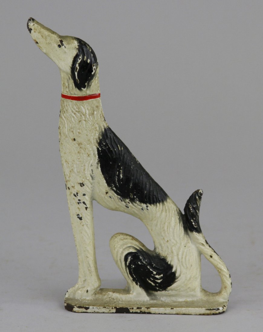 WOLFHOUND DOORSTOP: "Spencer Guilford, Conn," cast iron with wedge back design, depicts Russian Wolfhound in standing pose on base. 6 1/2" x 3 1/2".