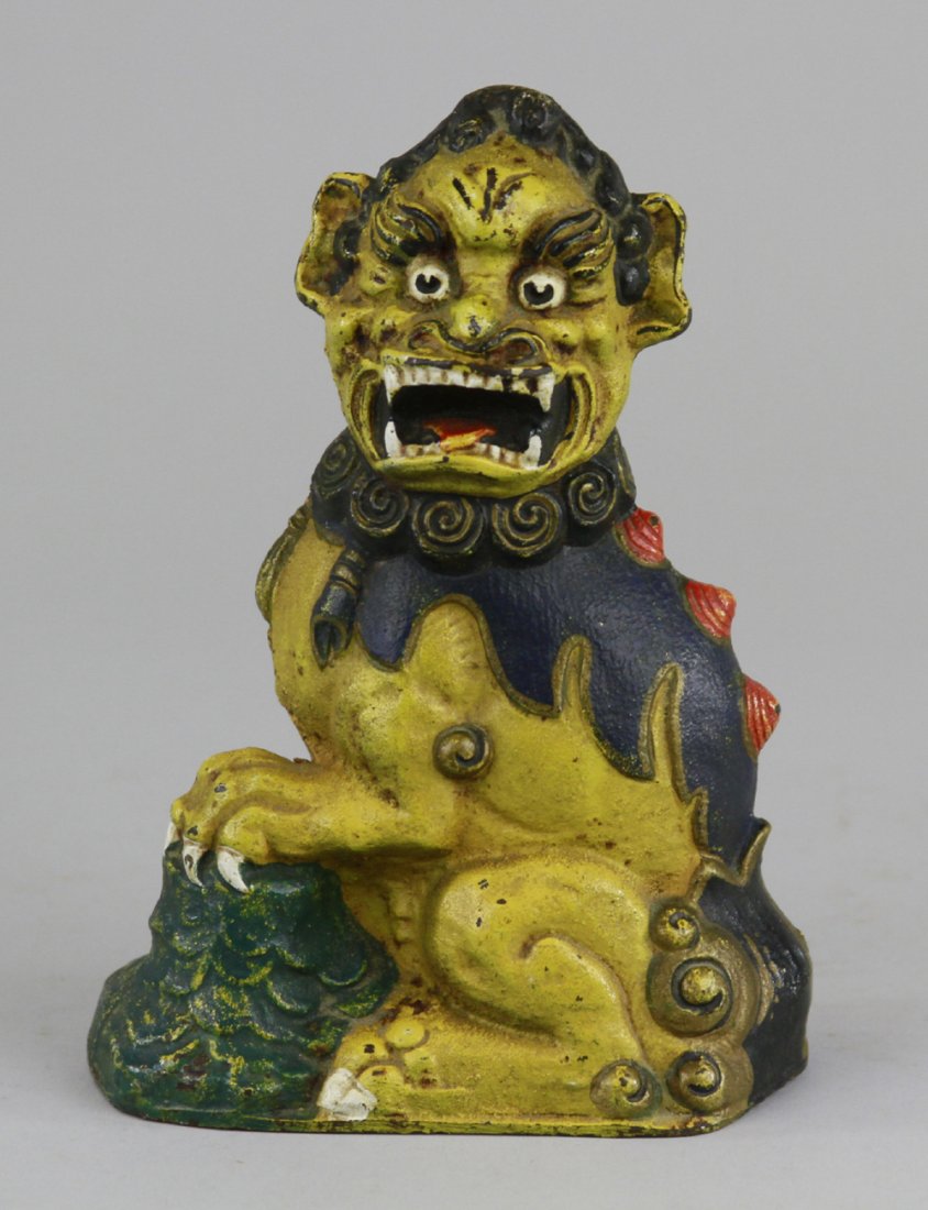 FOO DOG DOORSTOP: Full figure, depicts Chinese Foo dog in yellow & typical dress, painted in cheerful colors. 6 3/4" x 4 7/8".