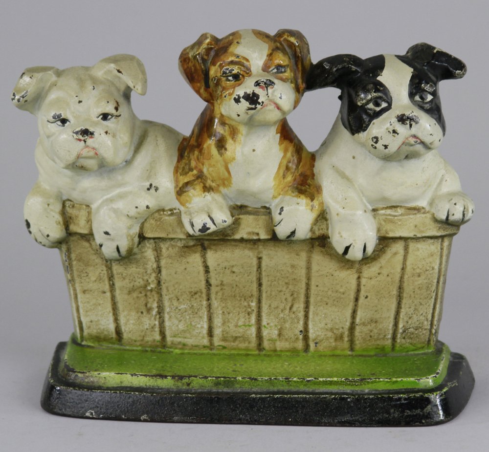 ENGLISH BULLDOG PUPPIES IN BASKET DOORSTOP: Copyright 1932 M. Rosenstein, Lancaster, PA, USA, whimsical depiction of three pups w/amusing expressions, posing on green base. 6 3/4" x 8 1/4".