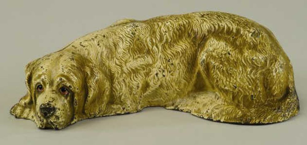 SAINT BERNARD DOORSTOP: Hubley, Cat. #388, wonderful full figured detailed casting of Saint Bernard laying down with faithful expression. 3 1/2" x 10 1/2".